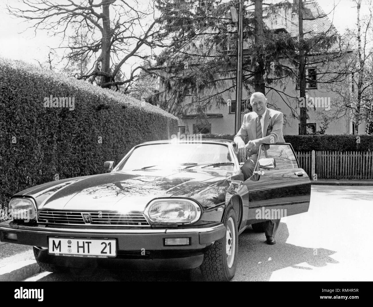 The actor Horst Tappert ('Derrick') next to his Jaguar XJ-S Coupe. Stock Photo