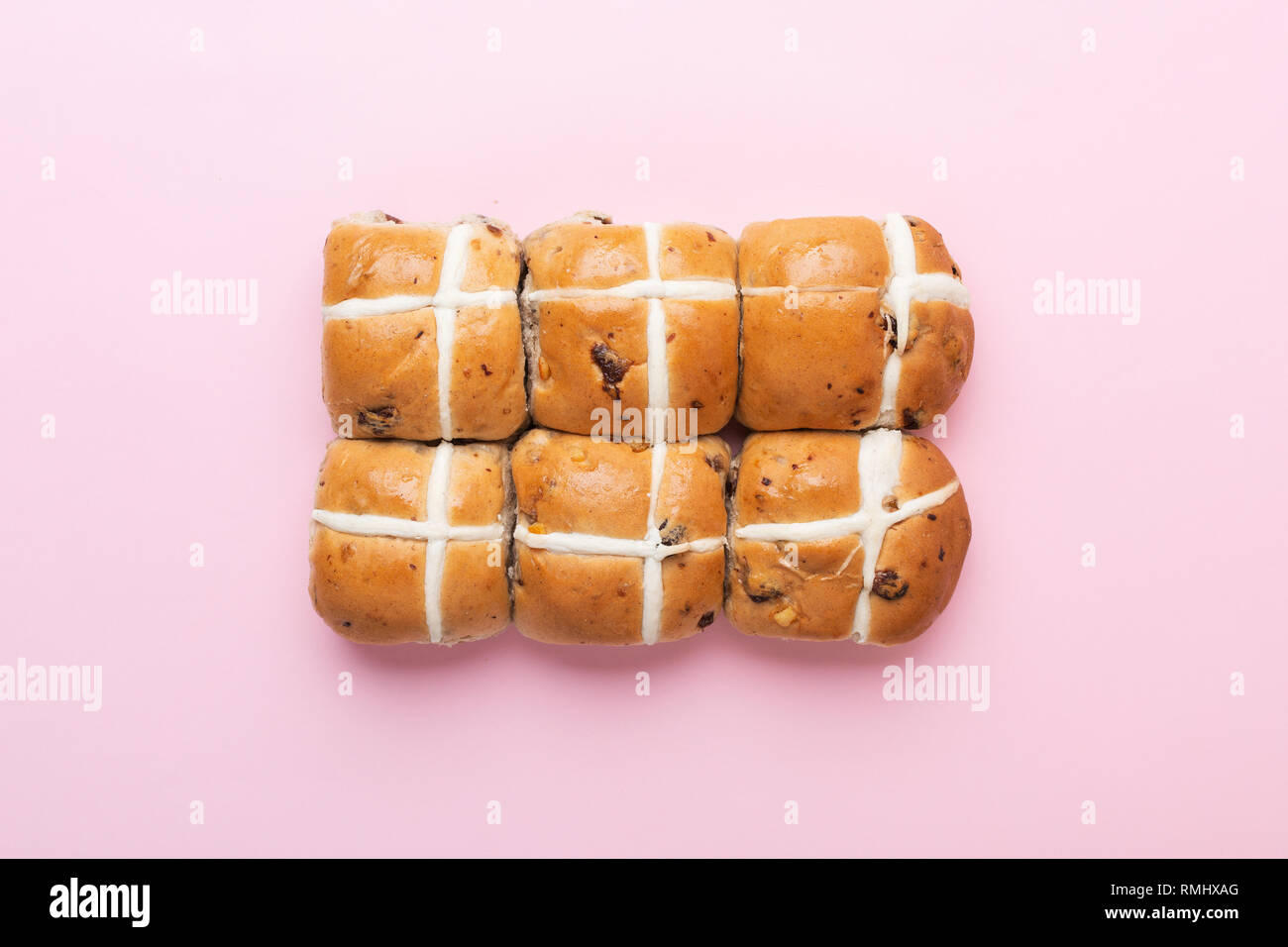 Six hot cross buns, traditional British Easter food on pink background ...