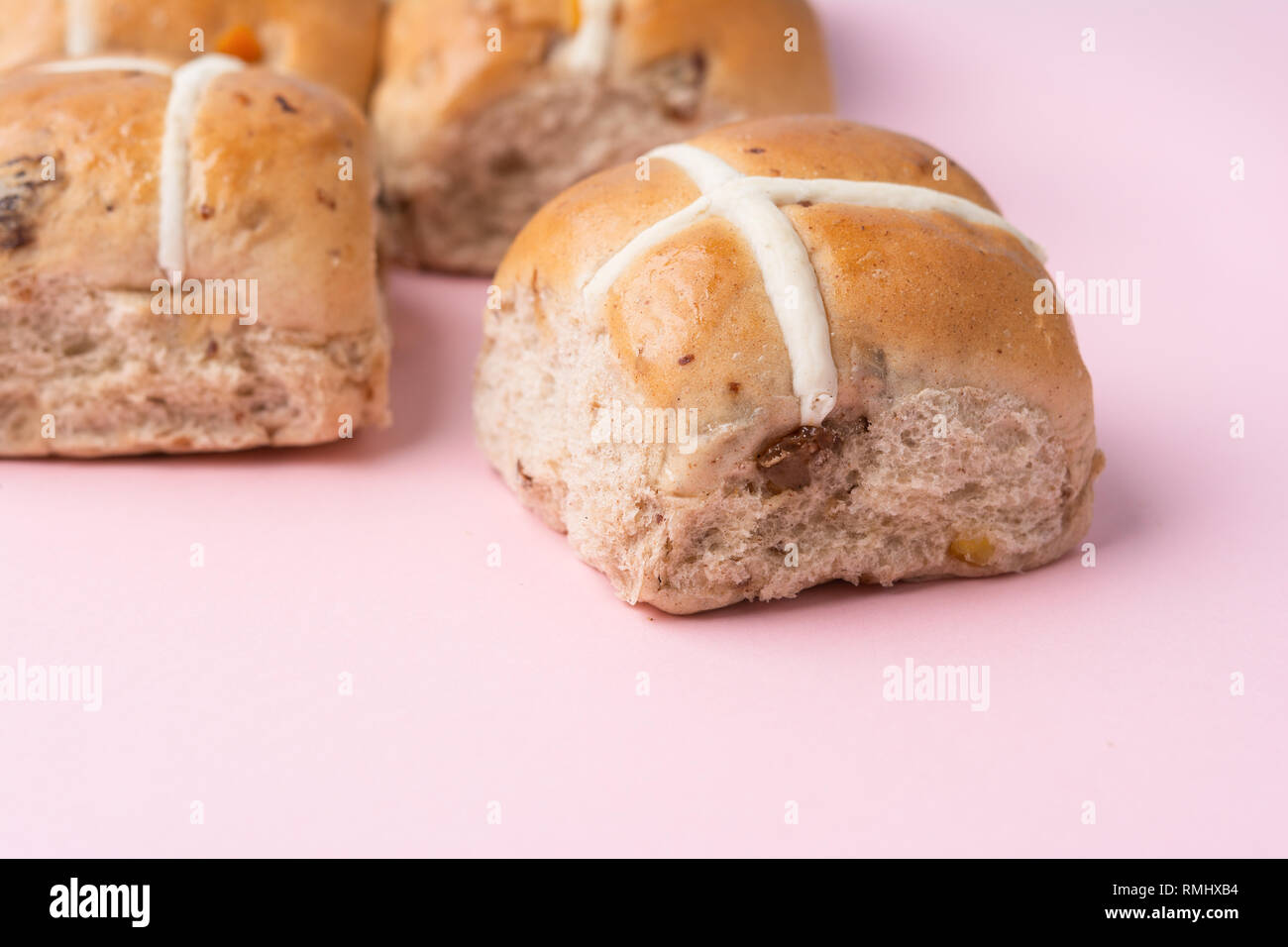 Hot cross buns, traditional British Easter food on pink background, selective focus Stock Photo