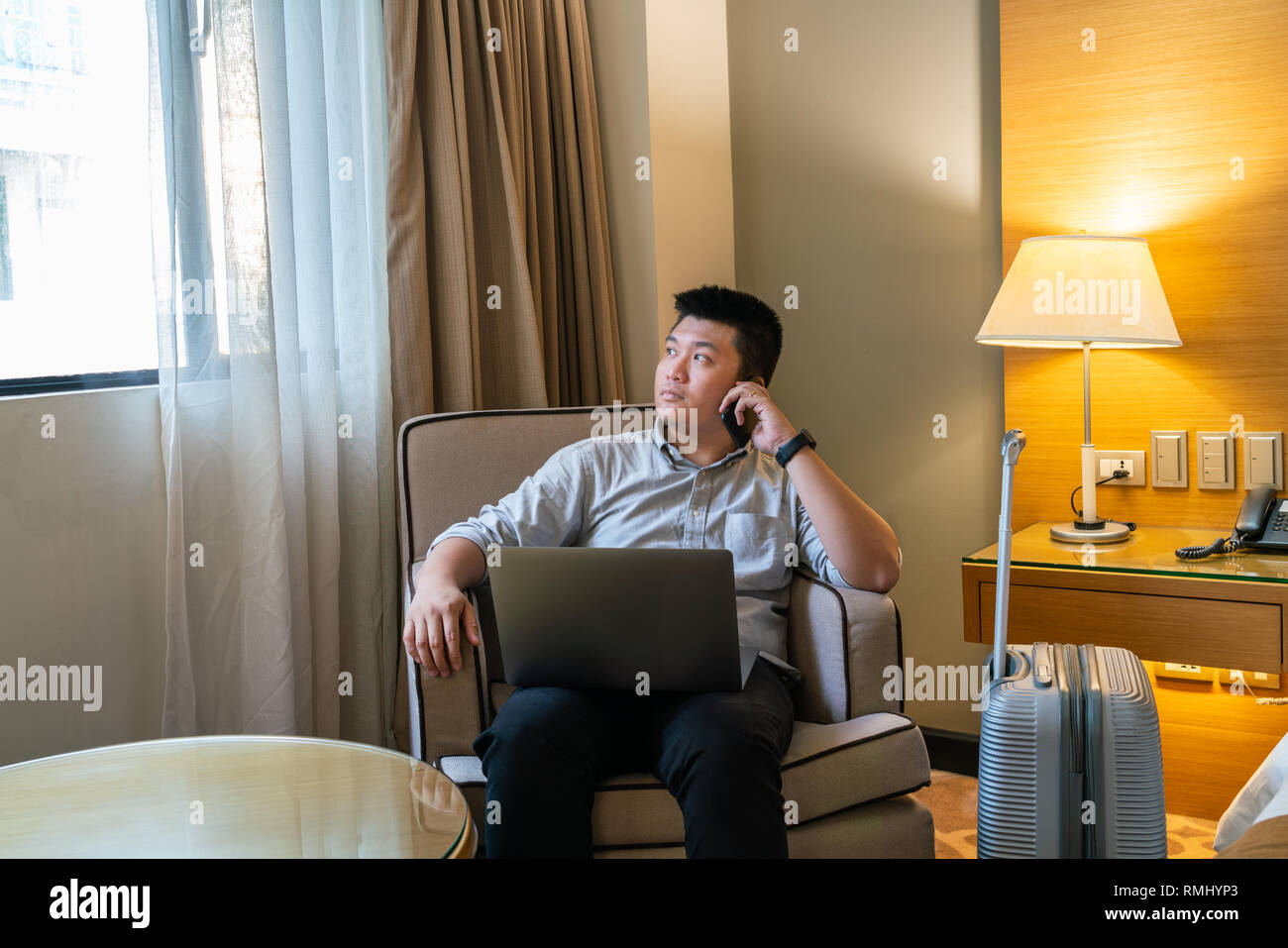 Asian man talking on smartphone Stock Photo