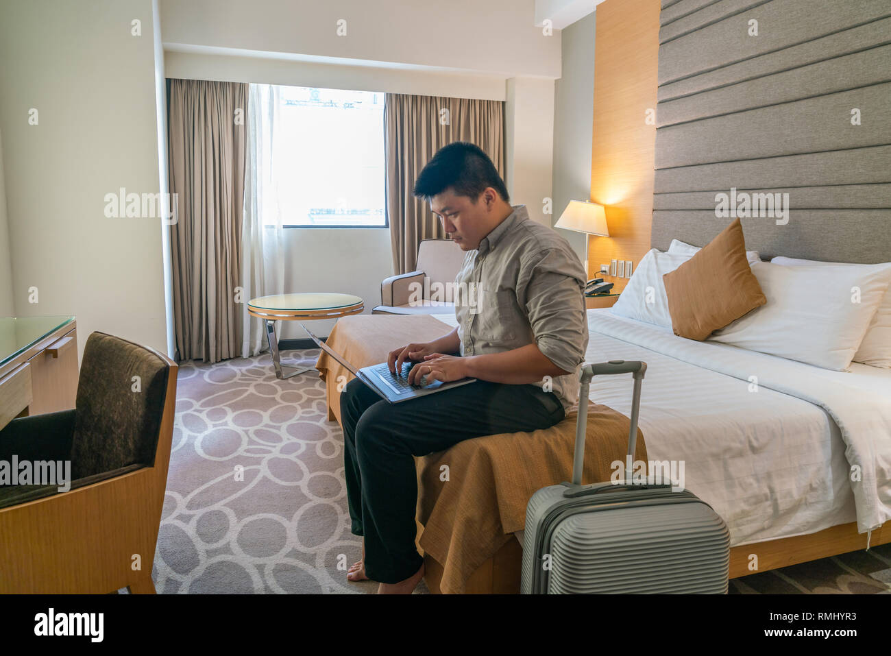 Young businessman working on laptop in business trip Stock Photo