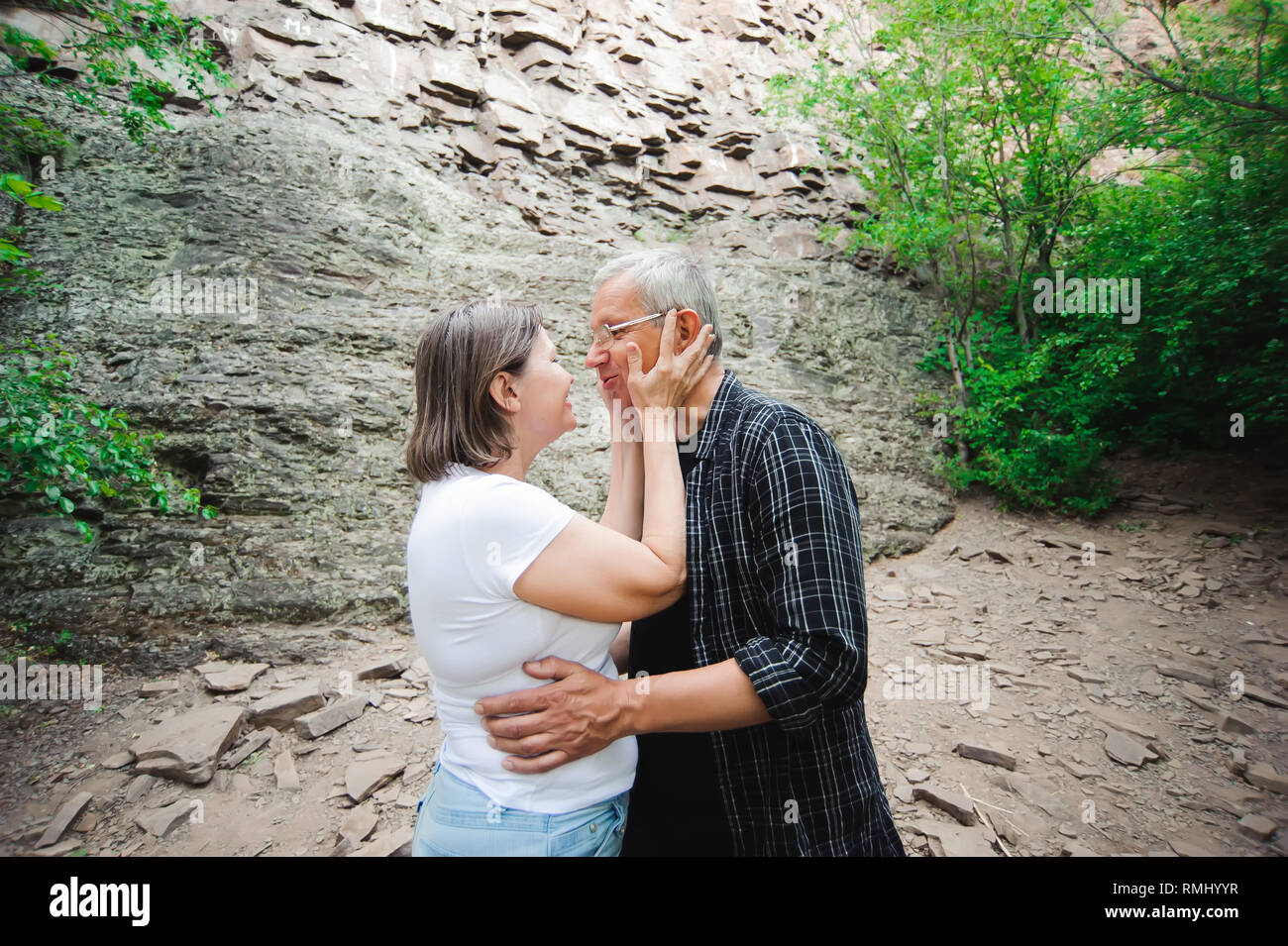 Active loving senior couple walking in beautiful summer forest Stock ...