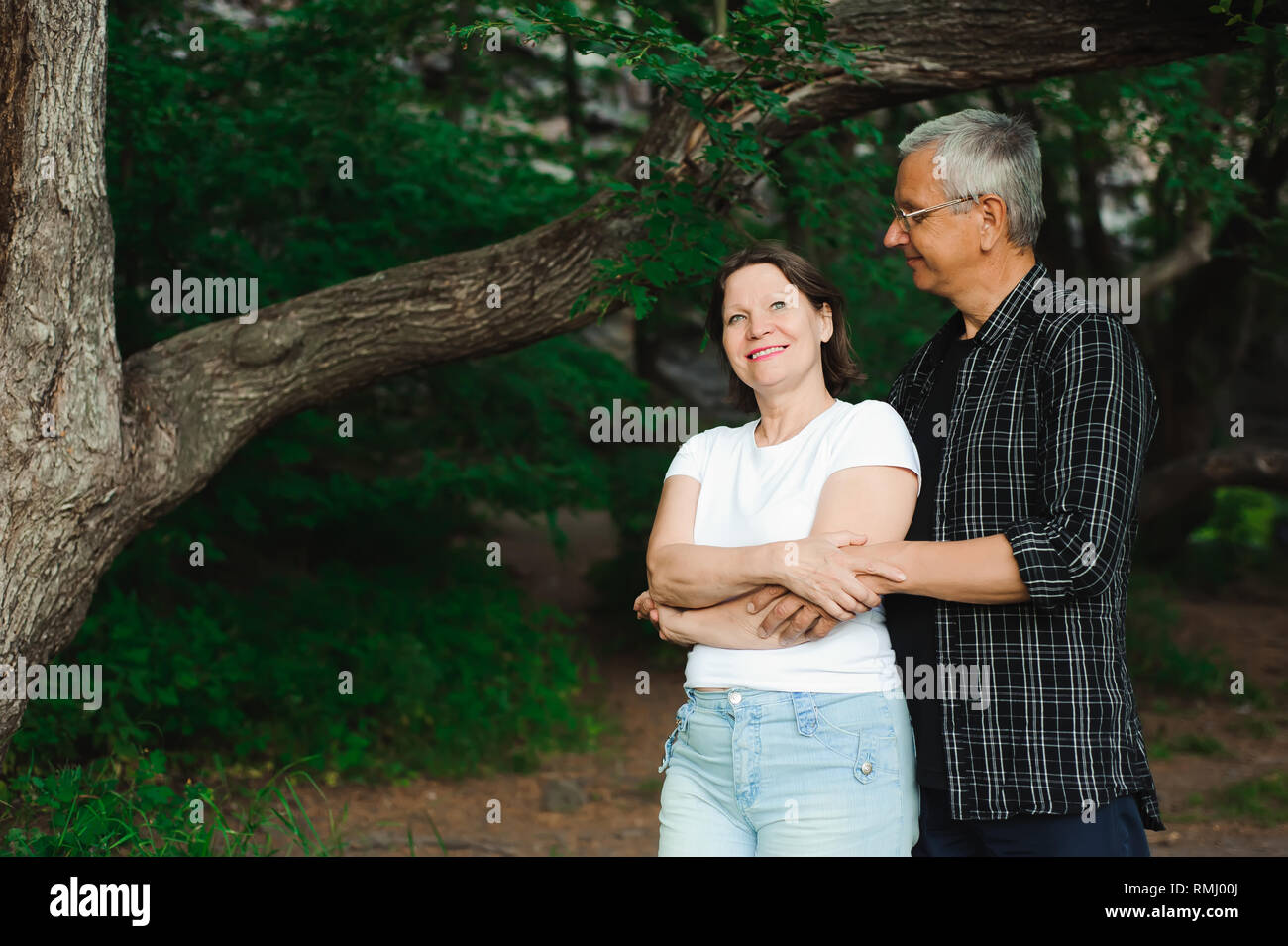 Senior couple walking together in a forest, close-up Stock Photo - Alamy