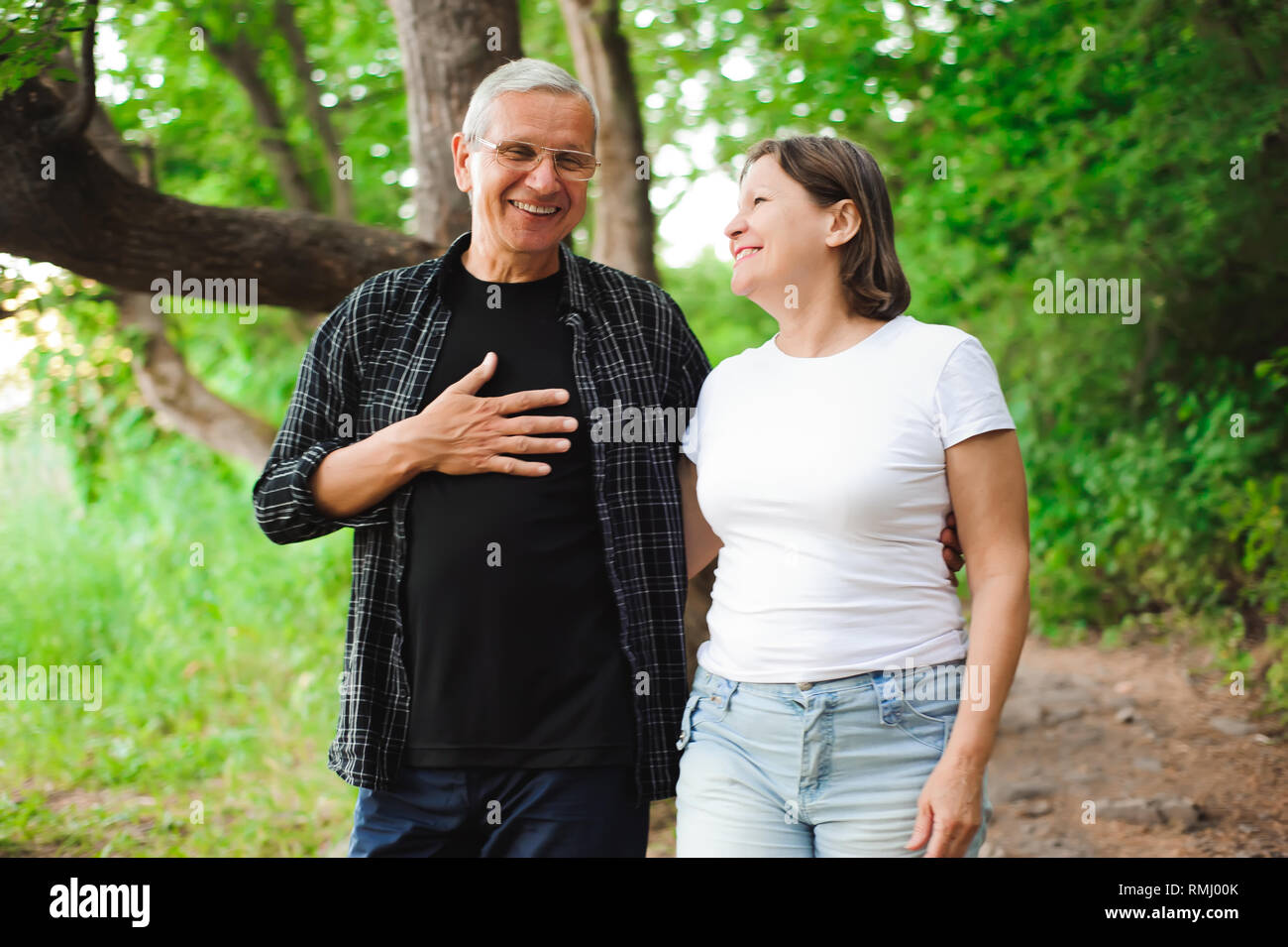 Senior couple walking together in a forest, close-up Stock Photo - Alamy