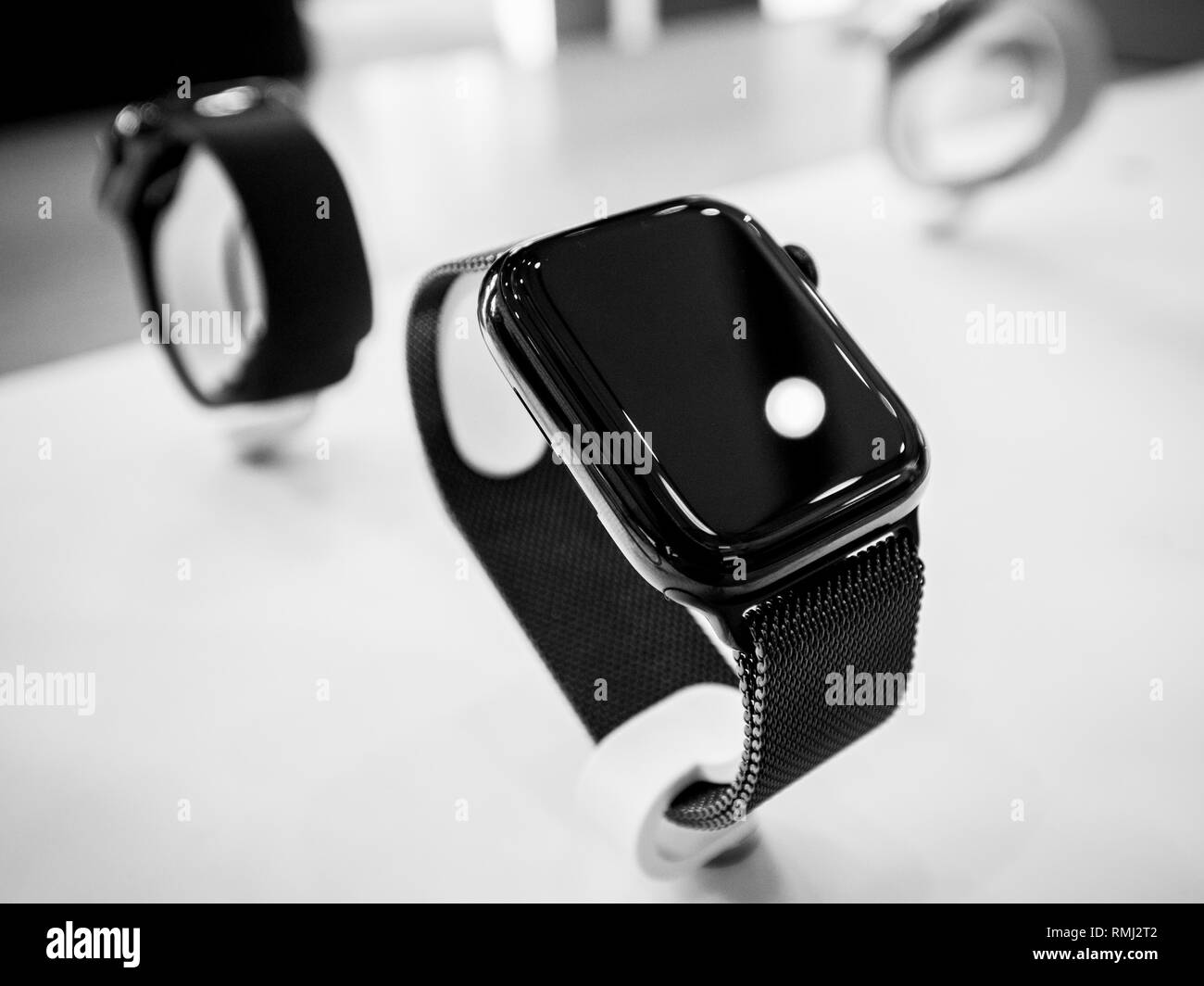 STRASBOURG, FRANCE - SEP 21, 2018: Apple Store with customers people buying admiring the new latest Apple Computers Watch Series 4 wearable black steel color - black and white Stock Photo