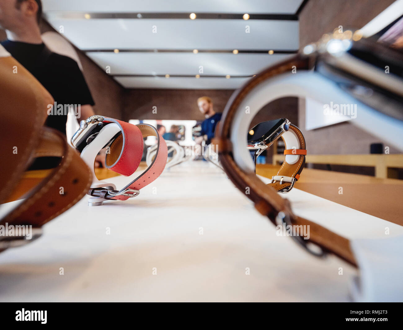 STRASBOURG, FRANCE - SEP 21, 2018: Apple Store with customers admiring the new latest Watch Series 4 wearable devices with diverse straps view through the watches wide angle Stock Photo