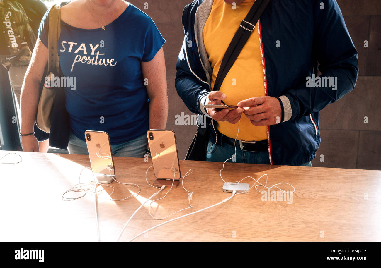 STRASBOURG, FRANCE - SEP 21, 2018: Adult couple admiring the gold iPhone Xs Max telephones in Apple Store during the day of the smartphones launch Stock Photo