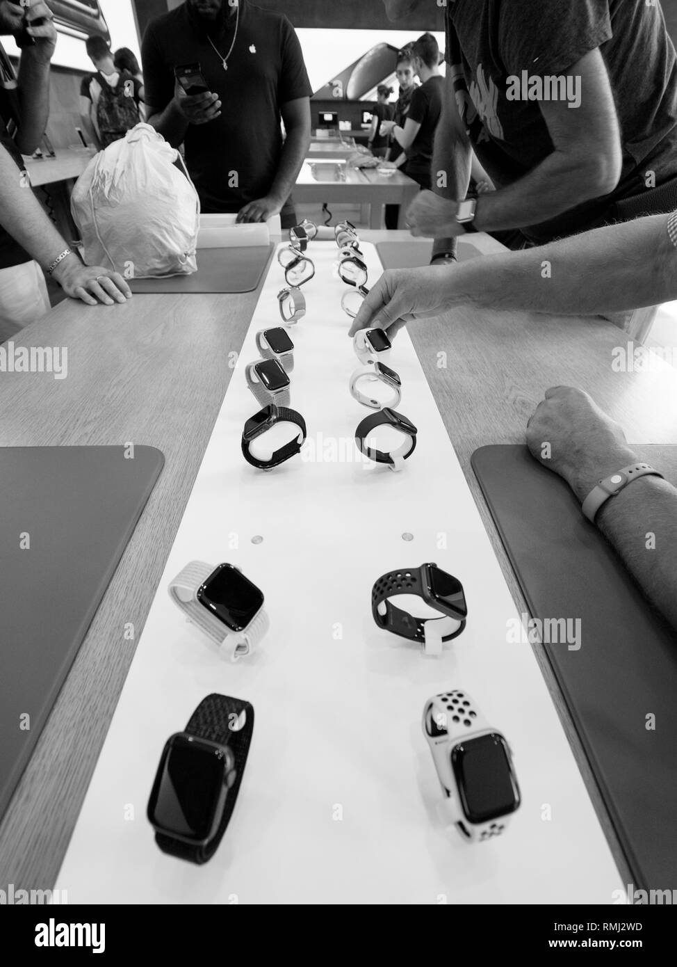 STRASBOURG, FRANCE - SEP 21, 2018: Black and white image of Apple Store with customers people buying admiring the new latest Watch Series 4 wearable smartwatch  Stock Photo