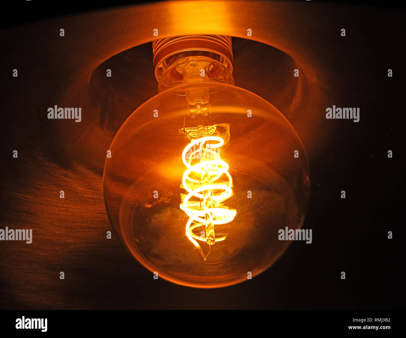 An incandescent electric light bulb, showing glowing filament, banned