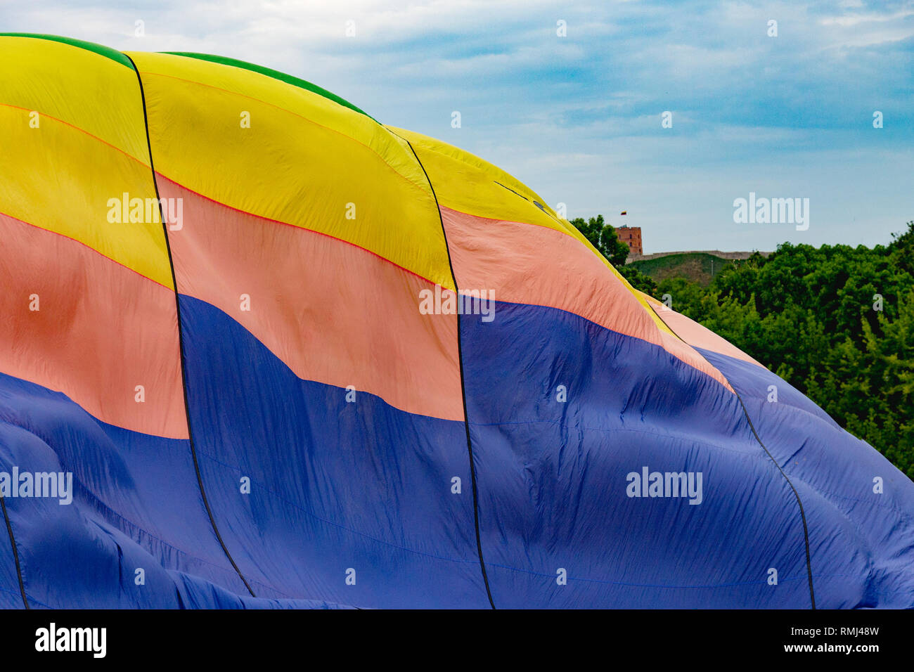 part of a multi-colored balloon against a cloudy sky Stock Photo