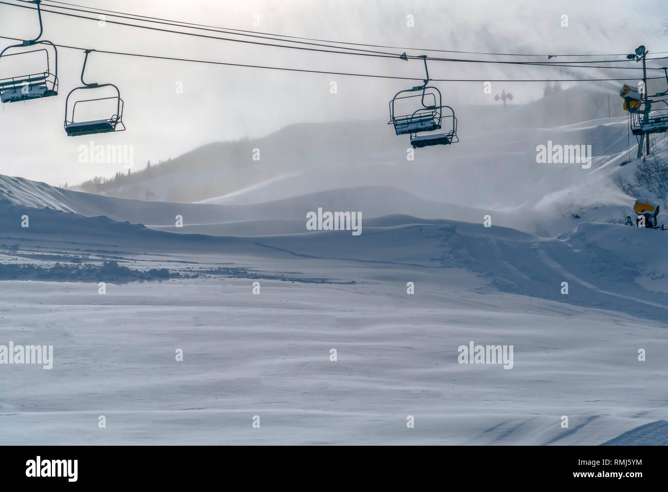 Chair lifts over mountain shrouded with snow Stock Photo Alamy