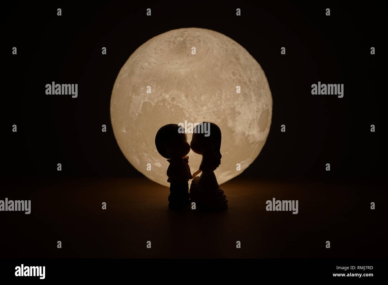 A silhouette of a couple looking at the full moon Stock Photo - Alamy