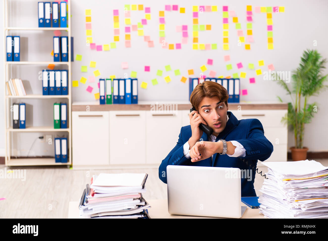 Young employee suffering from excessive work Stock Photo