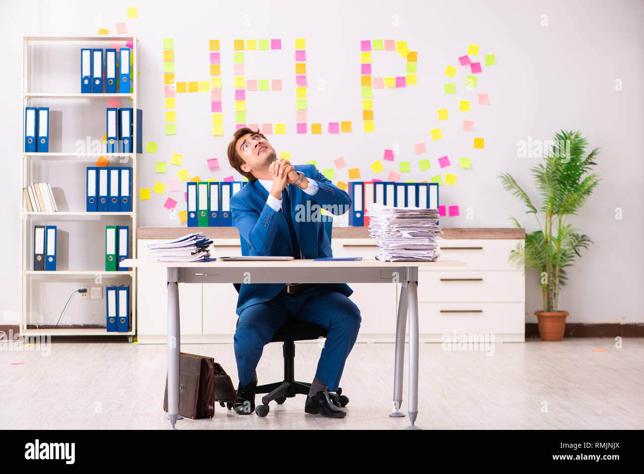 Young employee suffering from excessive work Stock Photo