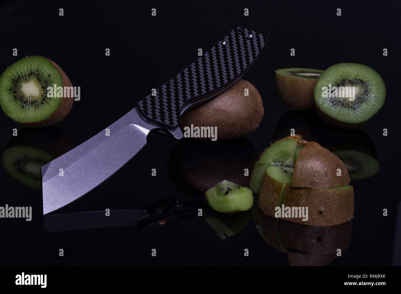 Chopper fruit slicing. Sliced Kiwi. Kiwi slices and knife. Stock Photo