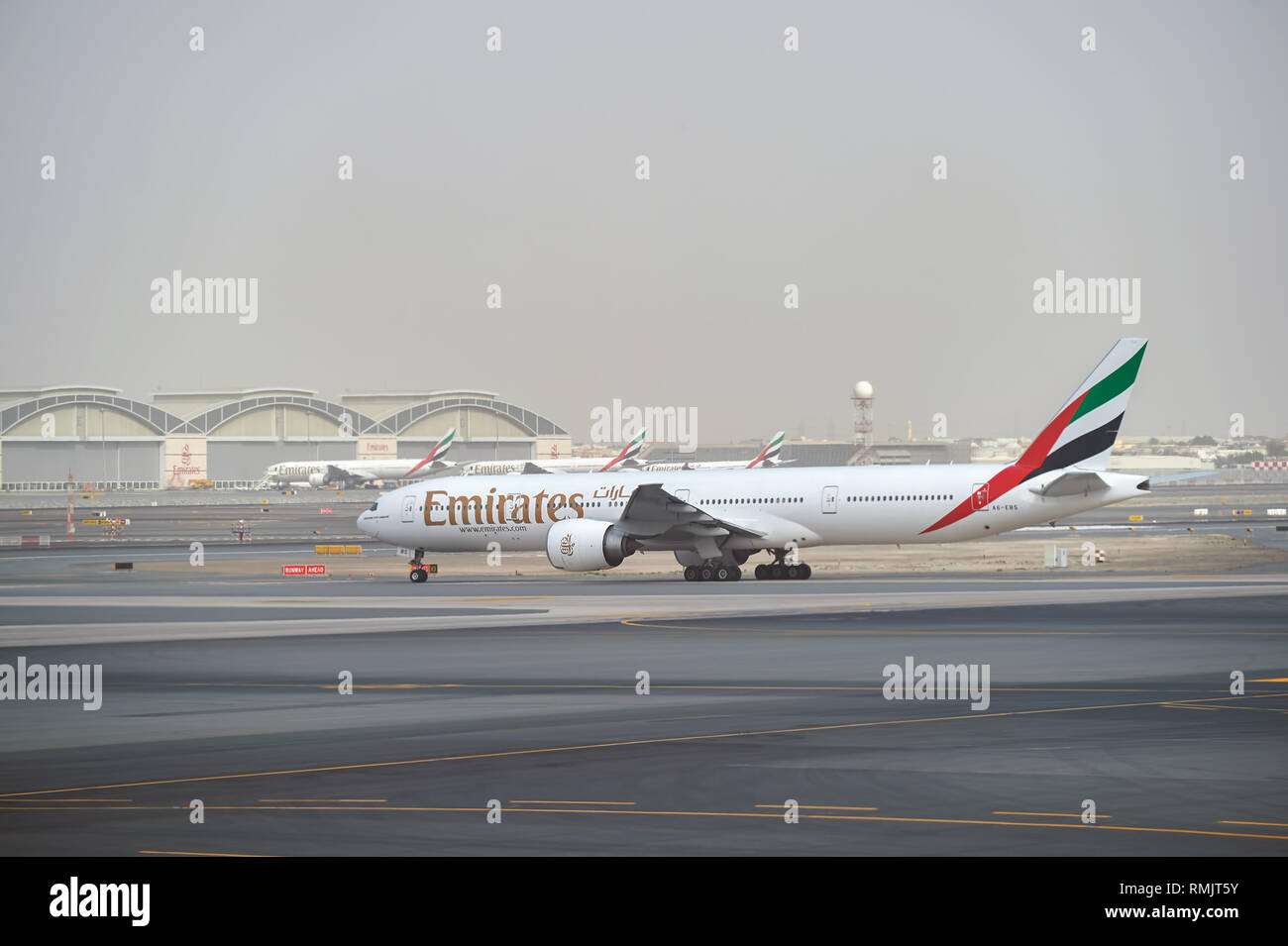 DUBAI, UAE - MARCH 10, 2015: Emirates Boeing 777 at Dubai International Airport. The Boeing 777 is a family of long-range wide-body twin-engine jet ai Stock Photo