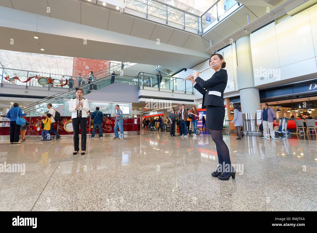HONG KONG - DECEMBER 24, 2015: Instrumental Flash Mob in Hong Kong Interntational Airport. Hong Kong Interntational Airport is the main airport in Hon Stock Photo