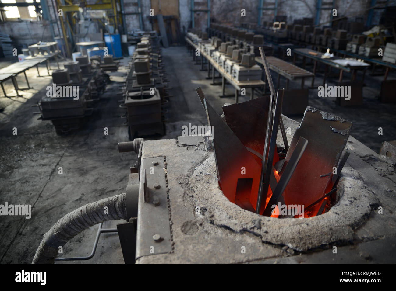 scrap steel melts down in an induction furnace at a small foundry Stock Photo