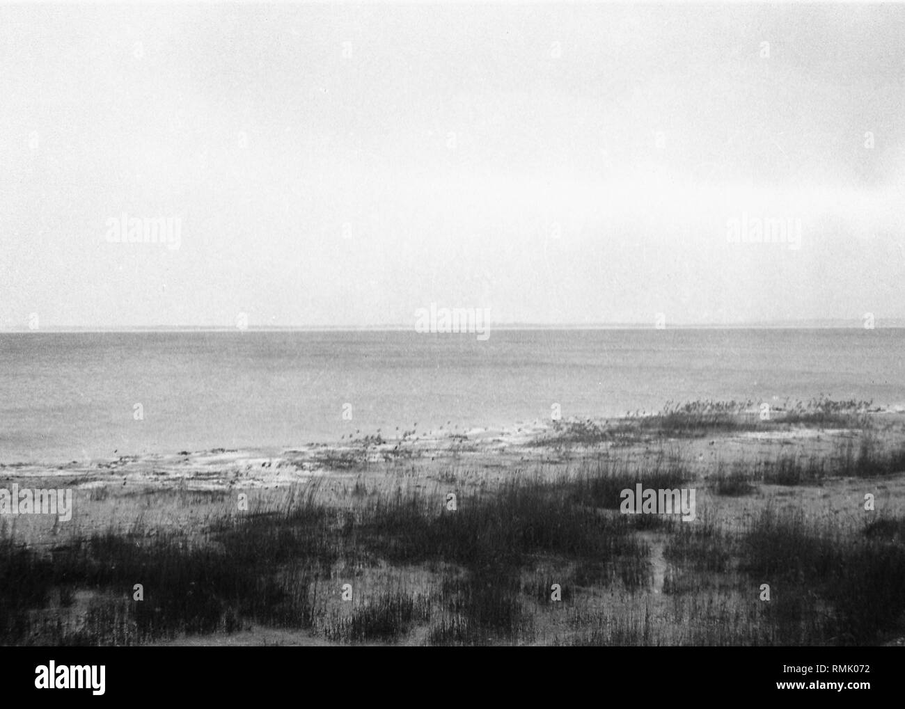 View from the Vistula Spit on the Gdansk Bay. At the beginning of February 1945, refugees attempt to flee across the ice of the Vistula Lagoon to the Vistula Spit to reach the Baltic Sea coast of Gdansk. The picture was taken by Theodor Vonolfen, the soldier of a Luftwaffe unit, deployed there at that time. Stock Photo