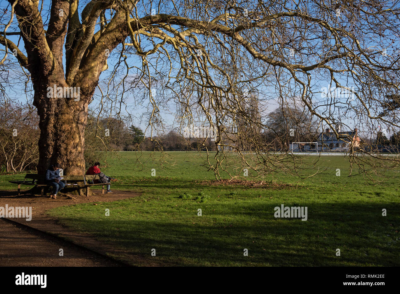 Students on a bench, Oxford University Parks in Winter Stock Photo