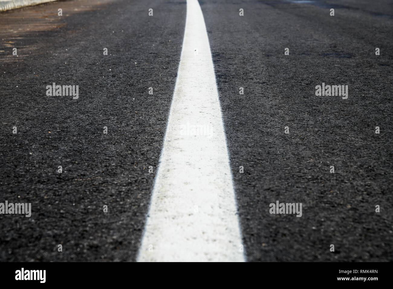 Asphalt road texture with white reflecting line. New road, surface a new asphalt highway Stock Photo