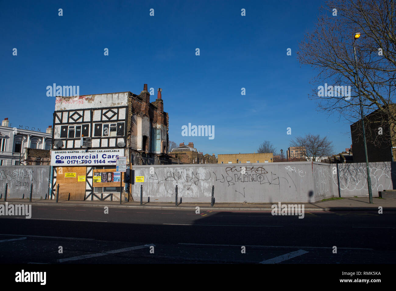 Demolished buildings leaving just one taxi office cars' on