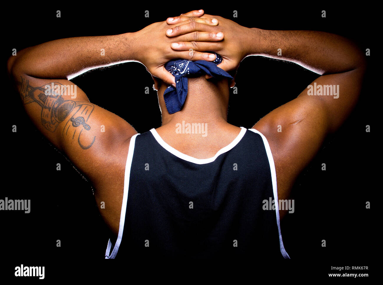 Black man with hands up behind his back is under arrest Stock Photo