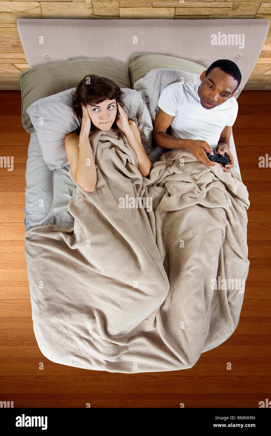 Female unable to sleep because of her gamer boyfriend stock photo alamy