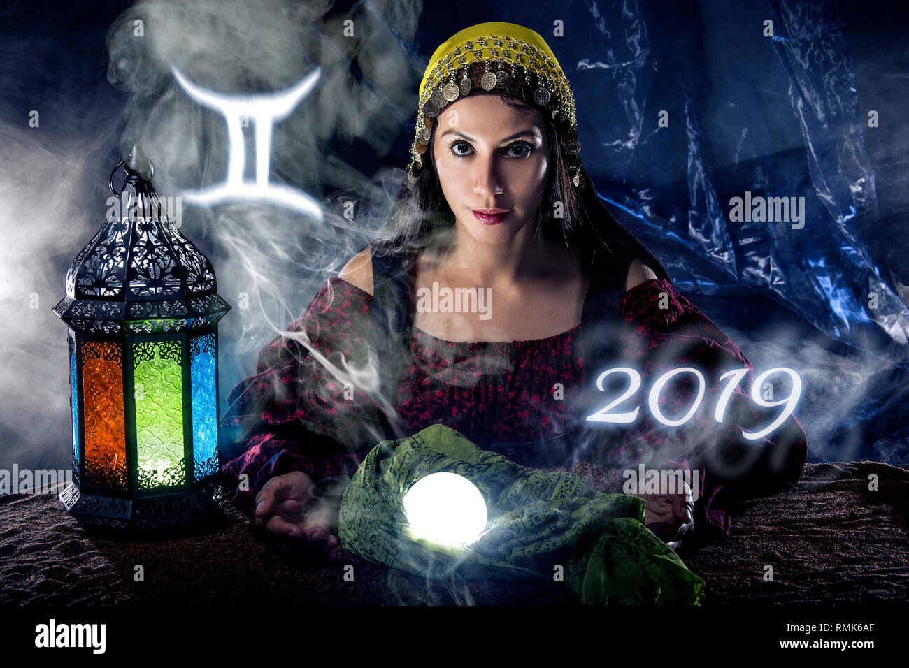 Psychic or fortune teller with crystal ball and horoscope zodiac sign