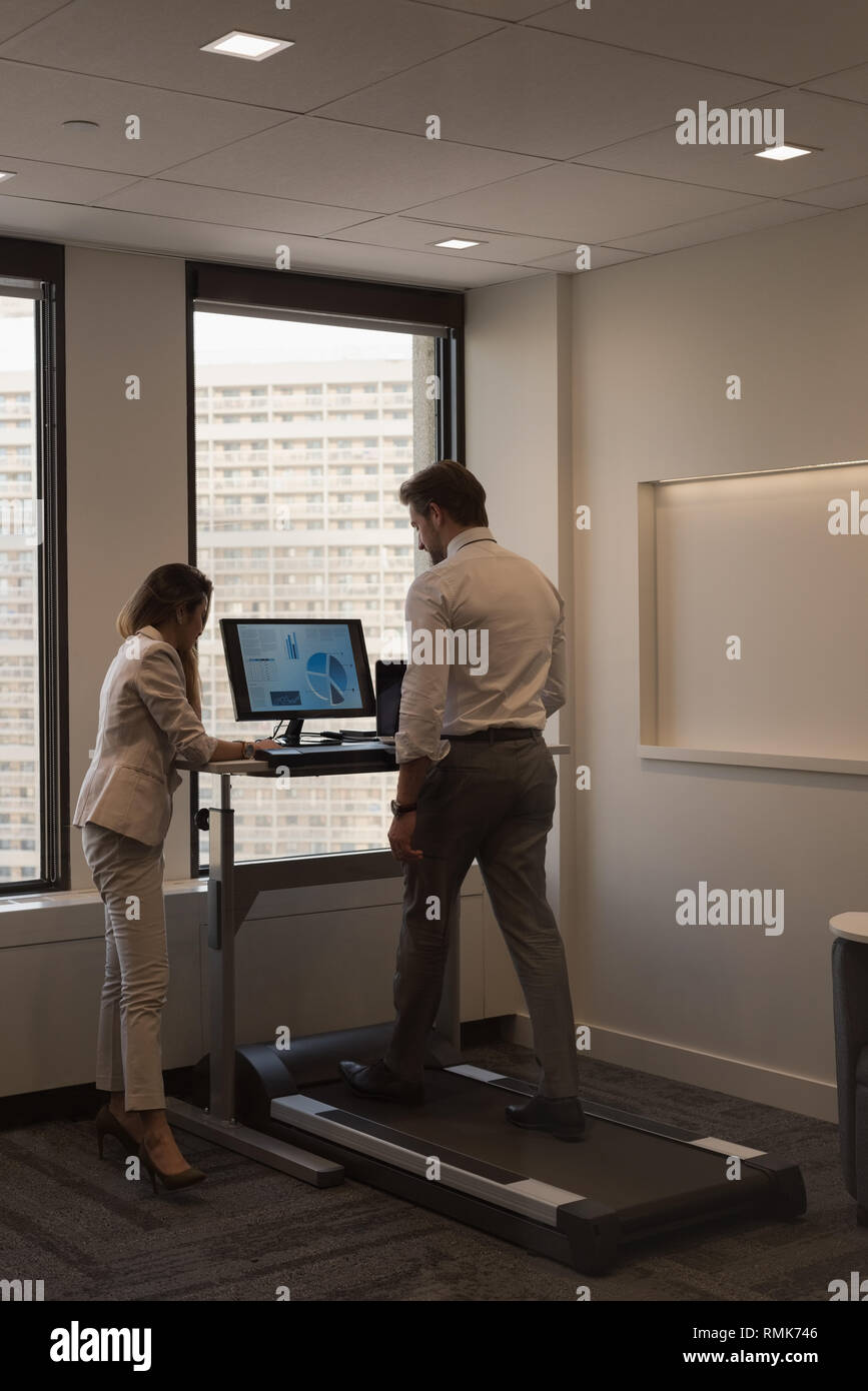 People discussing over documents in the office Stock Photo