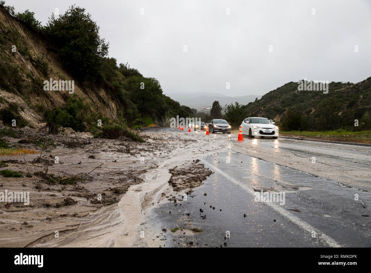 Vehicles drive up Rattlesnake Canyon Road during a rainstorm at Marine Corps Base (MCB) Camp