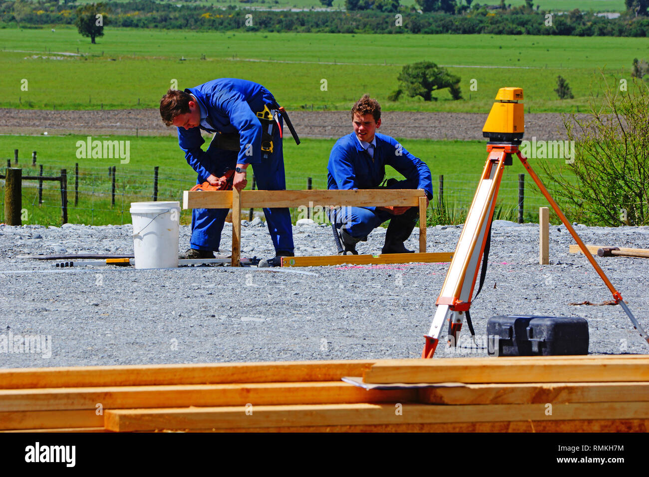 Builders mark out the profile for a building at a construction site in ...