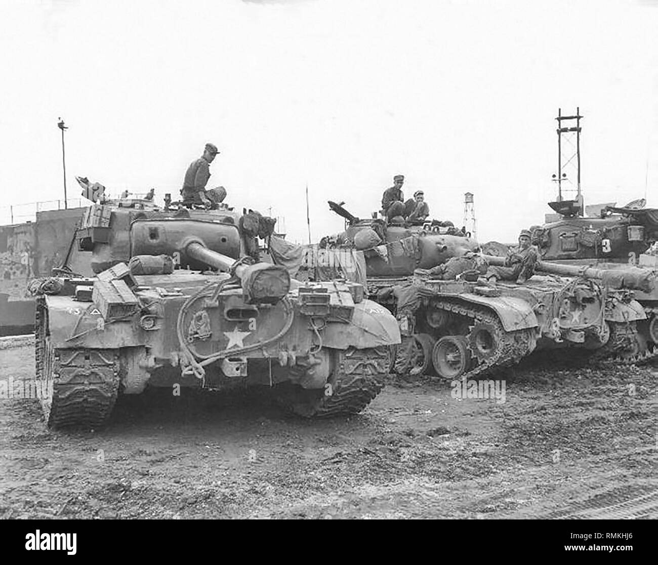 Men and equipment of the 73rd Heavy Tank Battalion await orders to