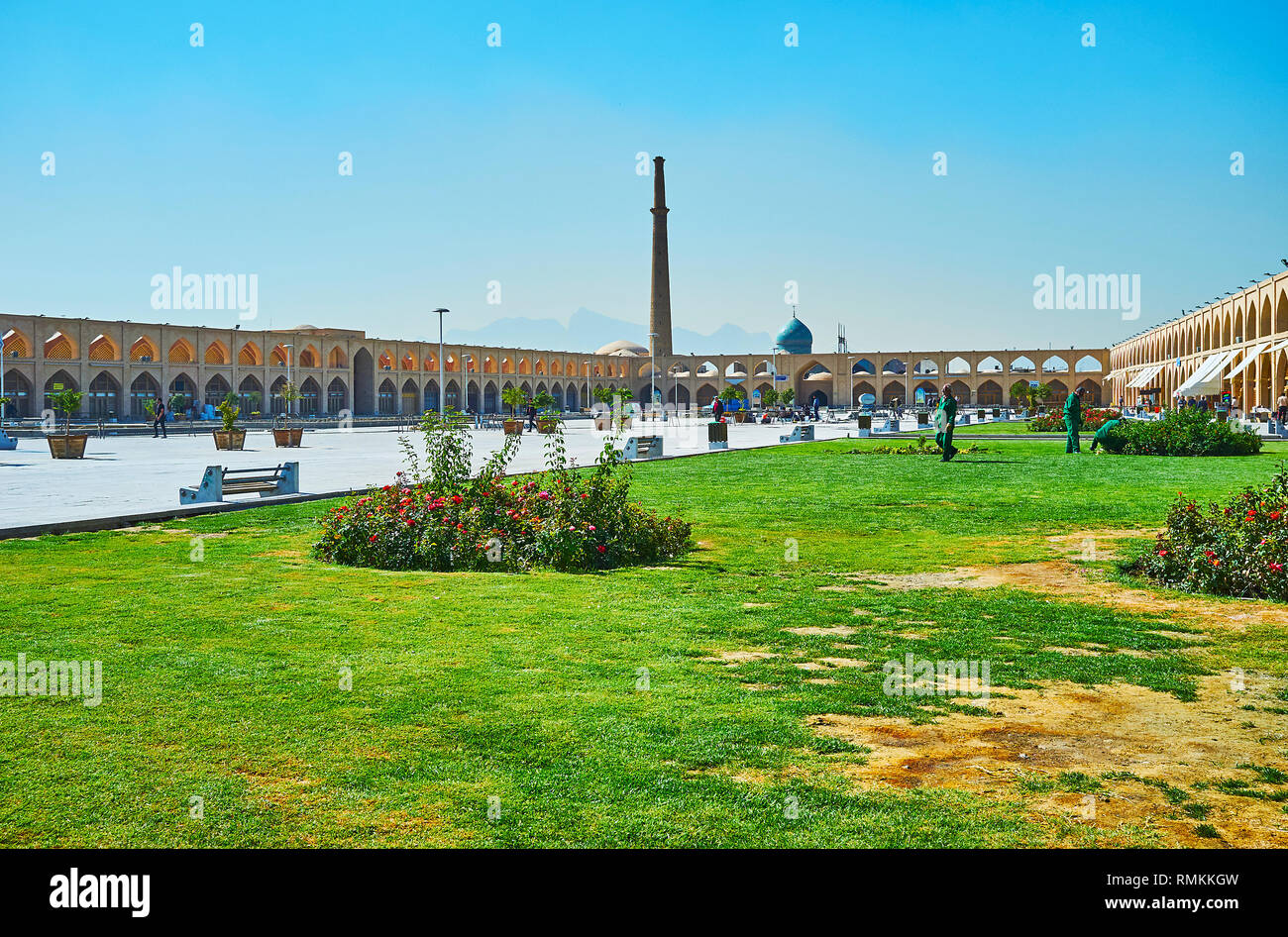 ISFAHAN, IRAN - OCTOBER 21, 2017: The almost restored Imam Ali (Atiq, Kohneh) Square is decorated with flower beds and lawn; historic bazaar complex a Stock Photo