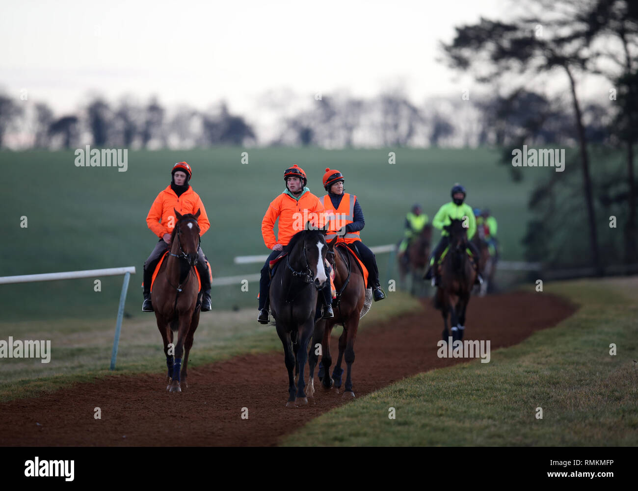 Horses and their riders exercise along the Warren Hill gallops in Newmarket Suffolk. Horse racing in Britain will resume tomorrow following a six day  Stock Photo