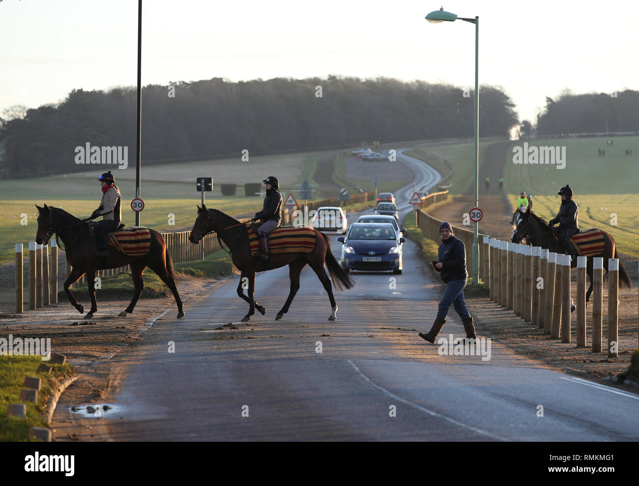 Horses and their riders exercise along the Warren Hill gallops in Newmarket Suffolk. Horse racing in Britain will resume tomorrow following a six day  Stock Photo