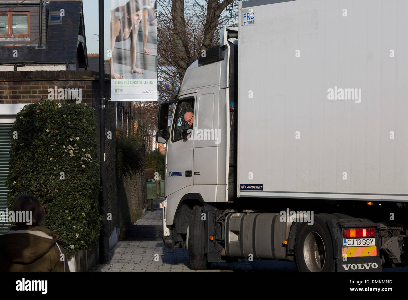 A Romanian-registered HGV lorry attempts to make a turn from Ferndene Road onto Herne Hill SE24, on 10th February 2019, in London, England. Large lorries regularly become stuck here while making this turn while following their SatNavs across south London roads. Stock Photo