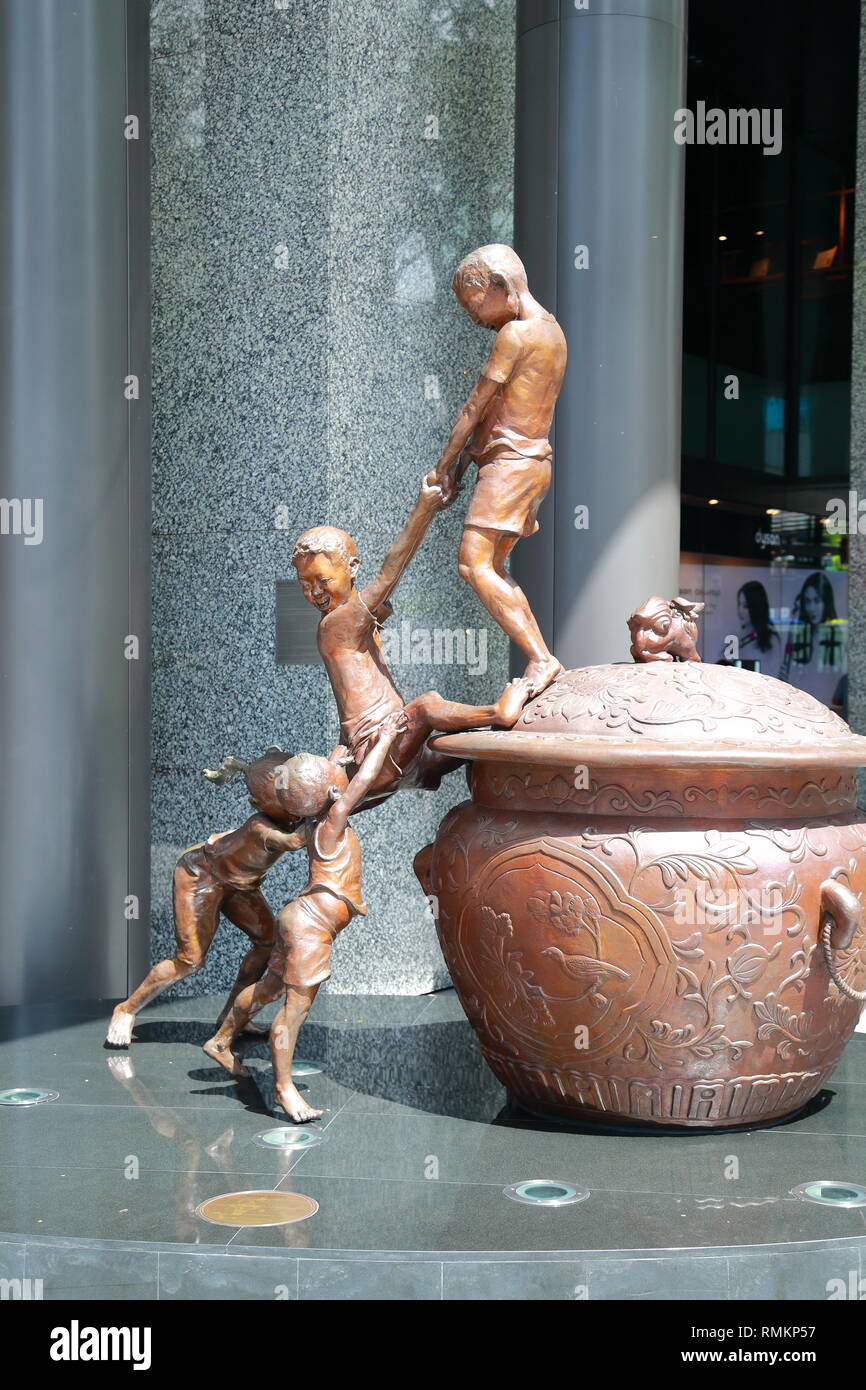 Bronze Sculpture of children playing in Orchard Rd, Singapore Stock