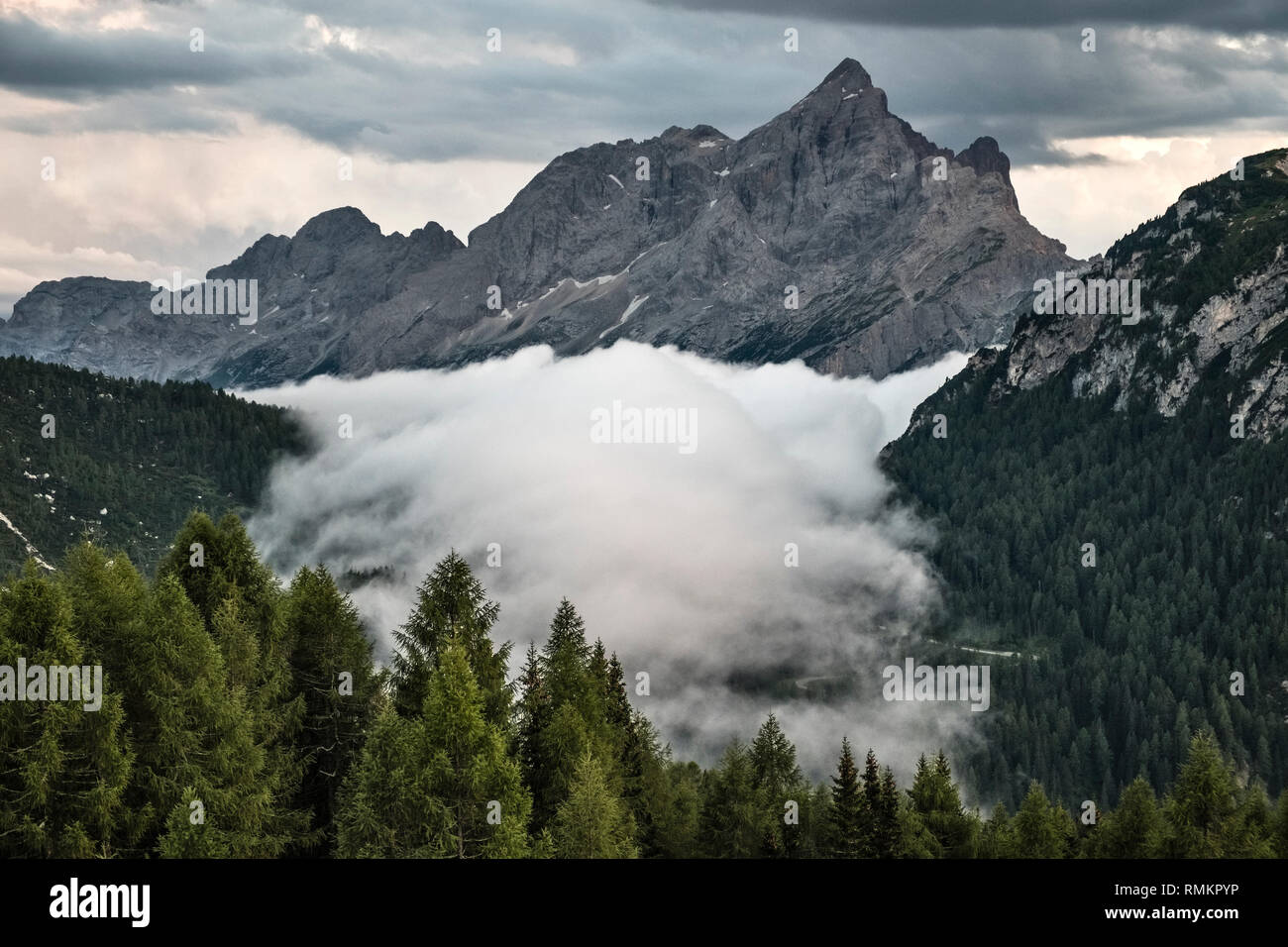 In the Italian Dolomites a temperature inversion causes a valley to fill with cloud Stock Photo