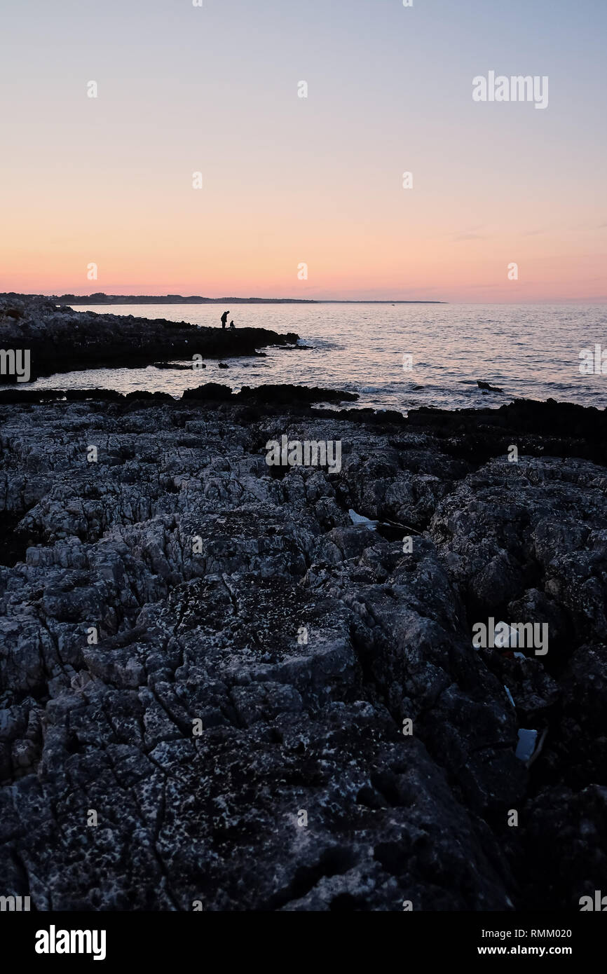 Fisherman by the sea at sunset. twilight, silhouettes Stock Photo - Alamy