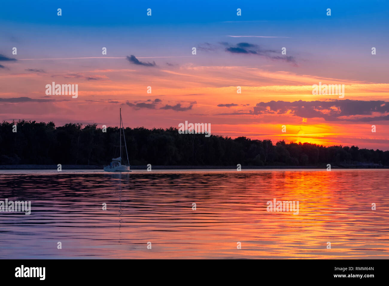 Yacht sailing on sunset, sunrise Stock Photo