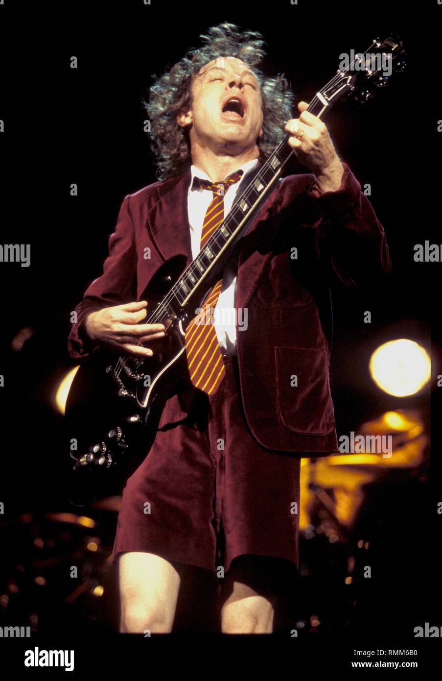 Ac/Dc guitarist Angus Young is shown performing on stage during a 'live' concert appearance. Stock Photo