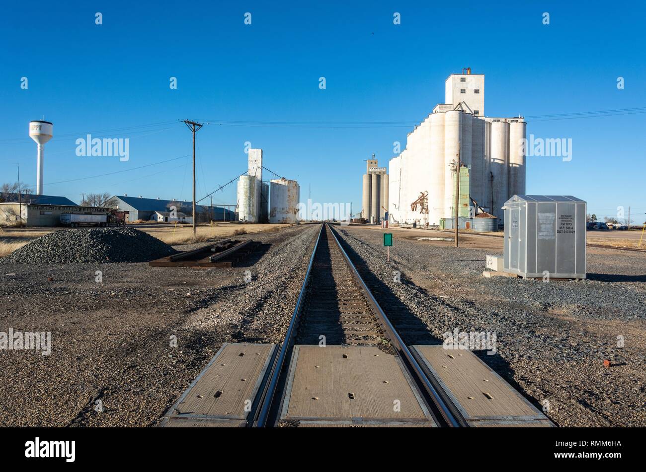 Happy, Texas, United States of America - January 1, 2017. Texas grain elevators along railroad tracks in Happy, TX. Stock Photo