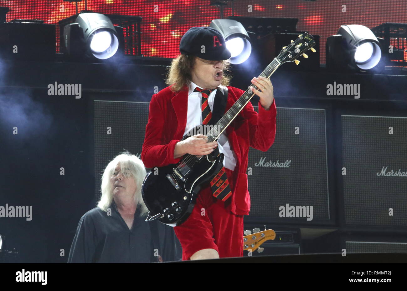 Guitarist Angus Young and bassist Cliff Williams are shown performing on  stage during a live concert appearance with Ac Dc Stock Photo - Alamy