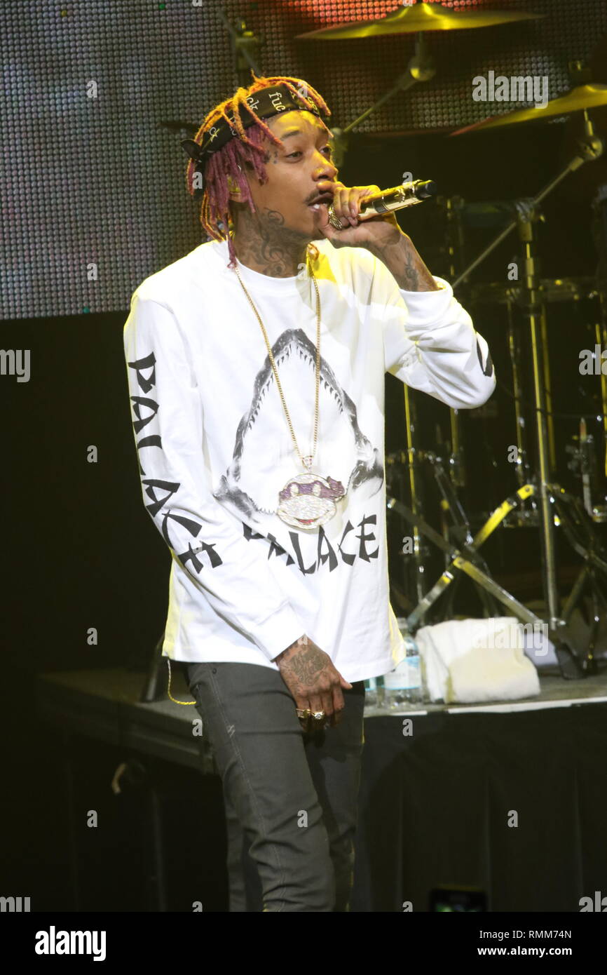 Rapper Wiz Khalifa is shown performing on stage during a "live" concert