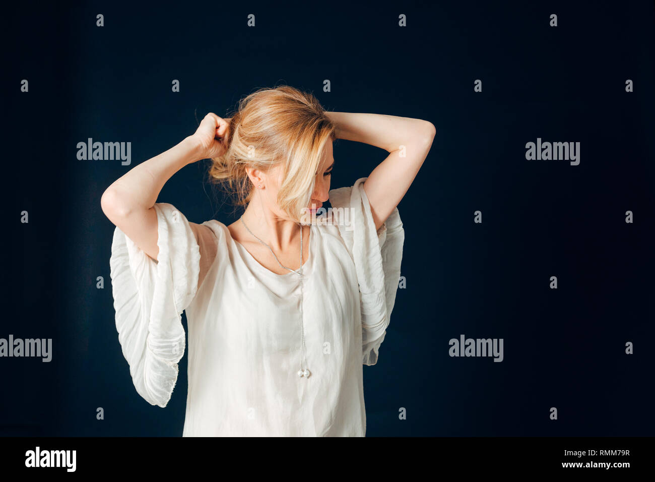 Close up studio portrait of a beautiful woman in the white dress ...