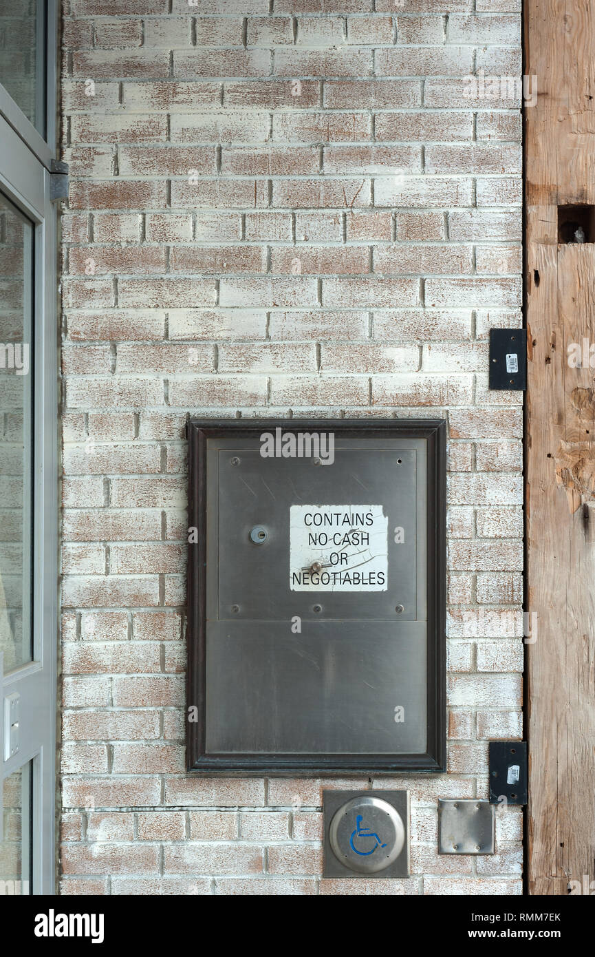 Security drop box in brick wall Stock Photo