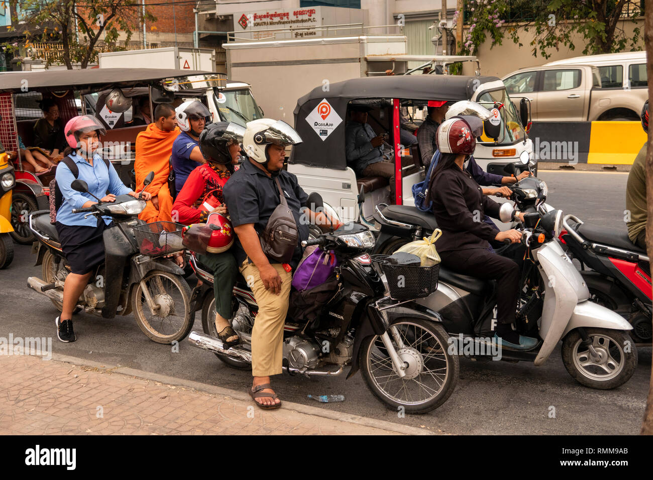 Cambodia, Phnom Penh, traffic congestion on city centre roads, motorcycles and tuk tuks amongst cars Stock Photo