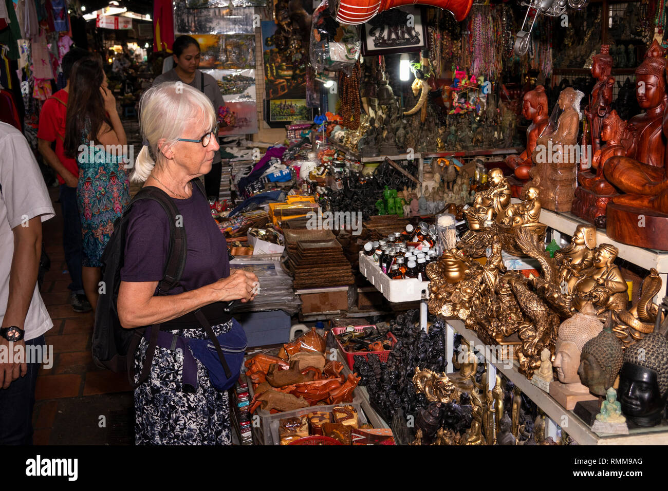 Cambodia, Phnom Penh, Chamkar Mon District, Russian Market, senior tourist shopping at souvenir stall Stock Photo