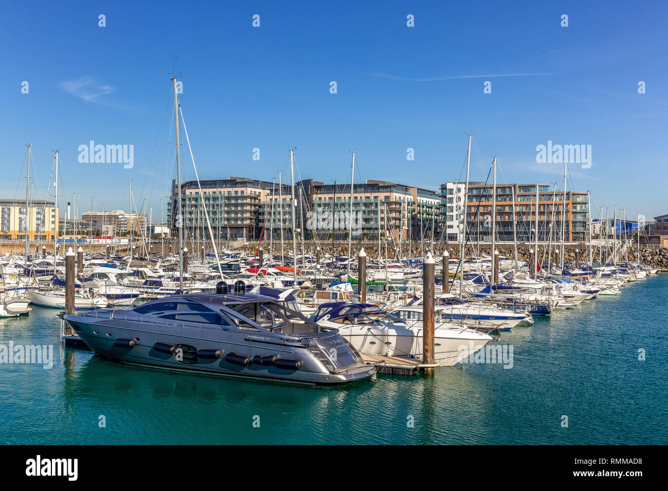 Castle Quay in Saint Helier on the Jersey on the Channel Islands. Shows many luxury boats moored up under a blue summer sky. Stock Photo